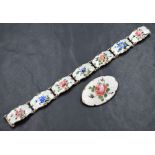 A silver guilloche enamel floral oval brooch depicting a rose, sold along with a matching