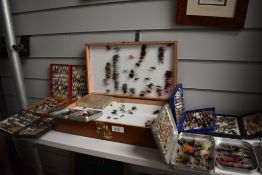 A large collection of Trout and Salmon flies in a double sided wooden case and 8 pocket boxes