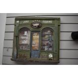 A wooden diorama depicting a vintage fishing tackle shop