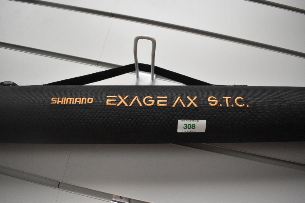 A Shimano Exage AX STC 6pc 2.7meter spinning rod in original soft sleeve and hard travel case