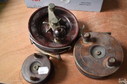 Three vintage reels an Alvey snapper 615c reel and two wood and brass reels