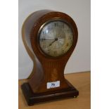 An Edwardian mahogany inlaid mantel clock, of balloon shape, raised on four brass metal feet,