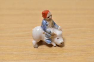 A scarce wade whimsie, depicting tiny elf riding a pig.
