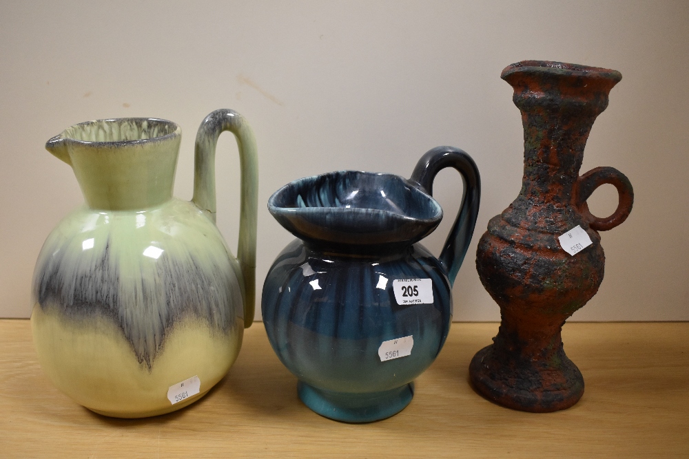 Three studio pottery jugs having decorative glazes.