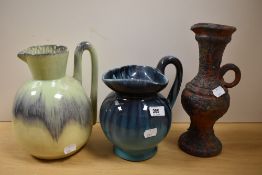 Three studio pottery jugs having decorative glazes.