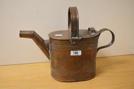 A Victorian copper fireside watering can, measuring 26cm high