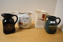 Four porcelain whisky jugs by Glengoyne, Glenkinchie, MacAllan, and Aberfeldy distilleries, the