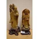Two 19th Century soapstone deities, Shou Lao and Guanyin, each raised on carved bases, the largest