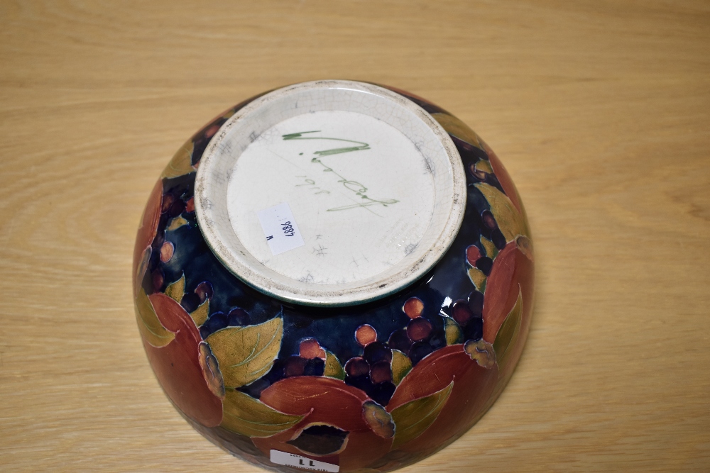 A Moorcroft Pottery fruit bowl, having tube lined grape and pomegranate design on cobalt blue - Image 3 of 4