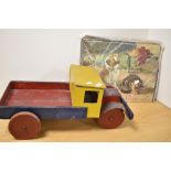 A cute vintage wooden jigsaw of pets and a large wooden toy truck.
