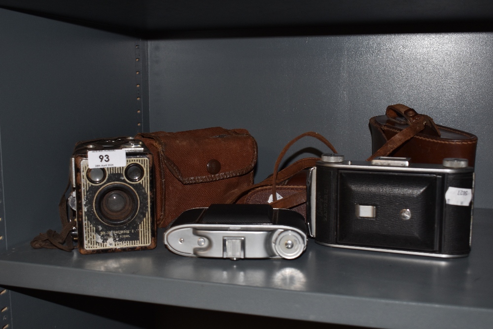 A 1940s Kodak Six-20 Brownie E camera, an Ensign Ranger II folding camera, and a Kershaw 110 folding