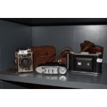 A 1940s Kodak Six-20 Brownie E camera, an Ensign Ranger II folding camera, and a Kershaw 110 folding