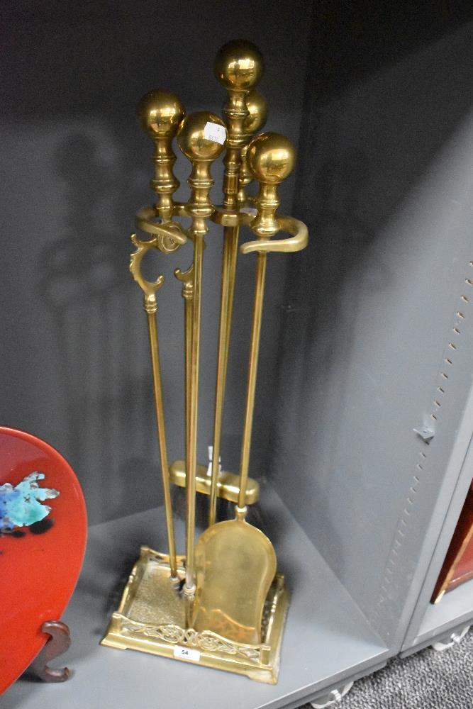 A Victorian brass fireside companion stand with tools, measuring 80cm tall