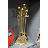 A Victorian brass fireside companion stand with tools, measuring 80cm tall