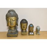 A group of four brass Buddha busts, of graduating sizes, the largest measures 32cm tall