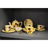 A mid-20th Century Carlton ware tea set, hand decorated with jolly men against a yellow ground, plus