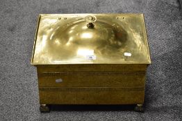 An Edwardian brass coal bin, having hinged lid, decorative banding design, and raised on four ball