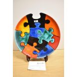 A 20th Century Poole pottery charger, of Jigsaw Puzzle design, a limited edition 144 of 250,