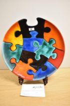 A 20th Century Poole pottery charger, of Jigsaw Puzzle design, a limited edition 144 of 250,