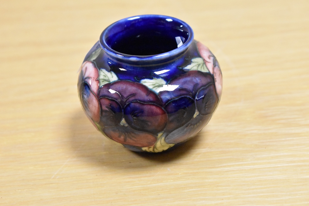 A William Moorcroft squat vase, in the Pansy pattern against a blue ground, measuring 6.5cm tall - Image 2 of 3