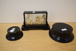 An Oriental cork diarama in ebonised case sold along with two ebonised dome bases.