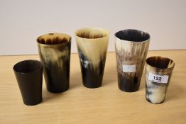 A group of five horn beakers of varying sizes, the largest measure 12cm tall