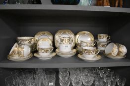 A selection of Noritake table ware, having white ground with gilt relief floral baskets and motifs.