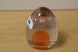 A Whitefriars domed glass paperweight with tangerine core and bubbled design Catalogue No 9695