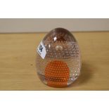 A Whitefriars domed glass paperweight with tangerine core and bubbled design Catalogue No 9695