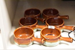 Six studio pottery soup dishes having brown and green glaze.