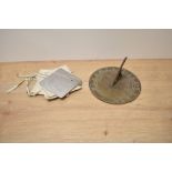 An antique brass sundial, having Welsh dragons to centre, approx 17cm, sold with a Heliograph