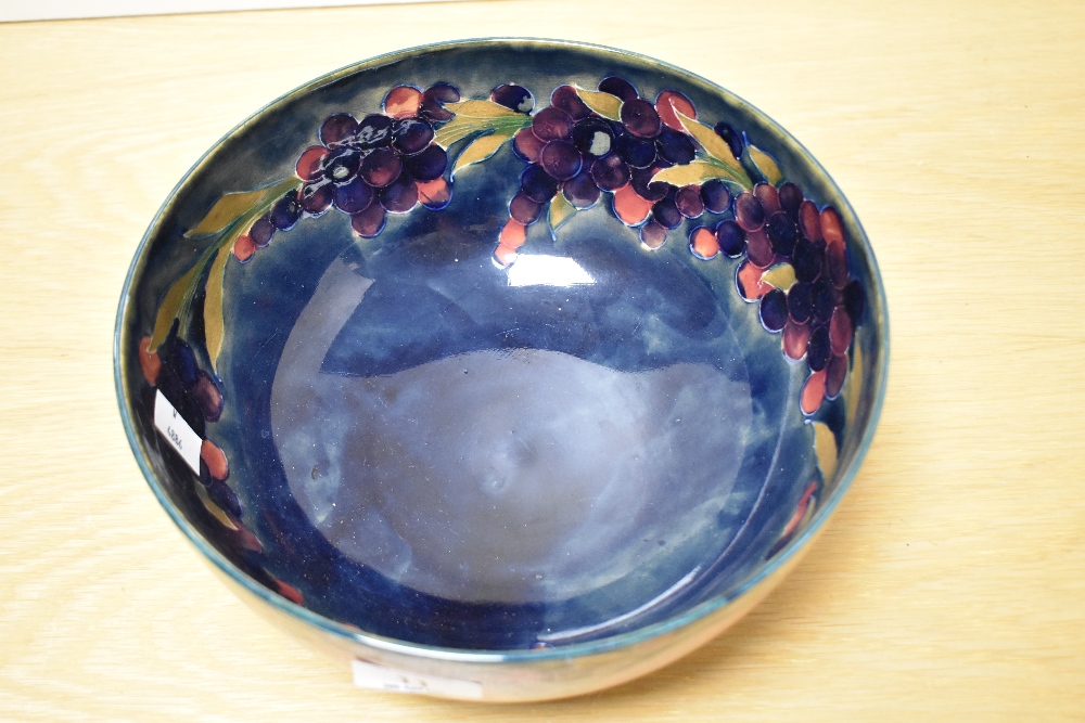 A Moorcroft Pottery fruit bowl, having tube lined grape and pomegranate design on cobalt blue - Image 2 of 4