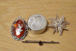 A collection of silver brooches including one of a filigree starburst design and a Thai red enamel