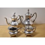 Two Victorian style silver plated footed coffee or tea pots, the largest measures 26cm tall, a cream