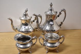 Two Victorian style silver plated footed coffee or tea pots, the largest measures 26cm tall, a cream