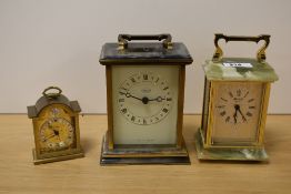 Two onyx and brass carriage clocks and a smaller similar alarm clock.