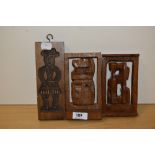 A 20th Century hand carved wooden butter mould with figural design, measuring 20cm tall, and two