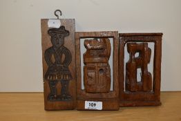 A 20th Century hand carved wooden butter mould with figural design, measuring 20cm tall, and two