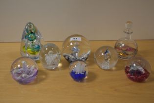 Seven assorted paperweights and a similar scent bottle including Karl Ittig 2015, Caithness and