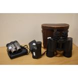 A pair of vintage 7x50 field binoculars with leather case, a pair of Minolta Compact II 10x25