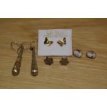 A collection of yellow metal earrings comprising a pair of decorative drop earrings, a pair of