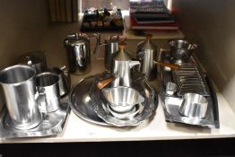 A large quantity of mid century stainless steel tableware including two chocolate pots, teapots, hot