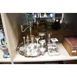 Two pairs of short silver plated candlesticks, a triple branch candelabra, a cruet stand and a