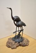 An appealing 20th century cast and patinated-metal ornithological sculpture, modelled as two