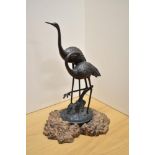 An appealing 20th century cast and patinated-metal ornithological sculpture, modelled as two