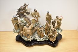 An impressive Shiwan Chinese Taoist stoneware figural tableau, depicting the eight immortals