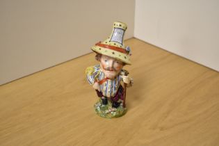 An early 19th century Derby porcelain mansion house dwarf, modelled dressed in opulent attire