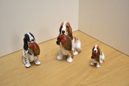 A group of three Royal Doulton Cocker Spaniels, comprising large cocker spaniel with pheasant