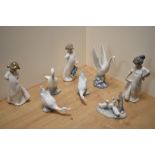 A group of eight Nao porcelain bird studies and figurines, three girls in nightdresses and white