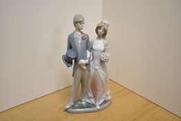A Lladro porcelain figure group Wedding Day number 1404, modelled as a bride and groom, printed,